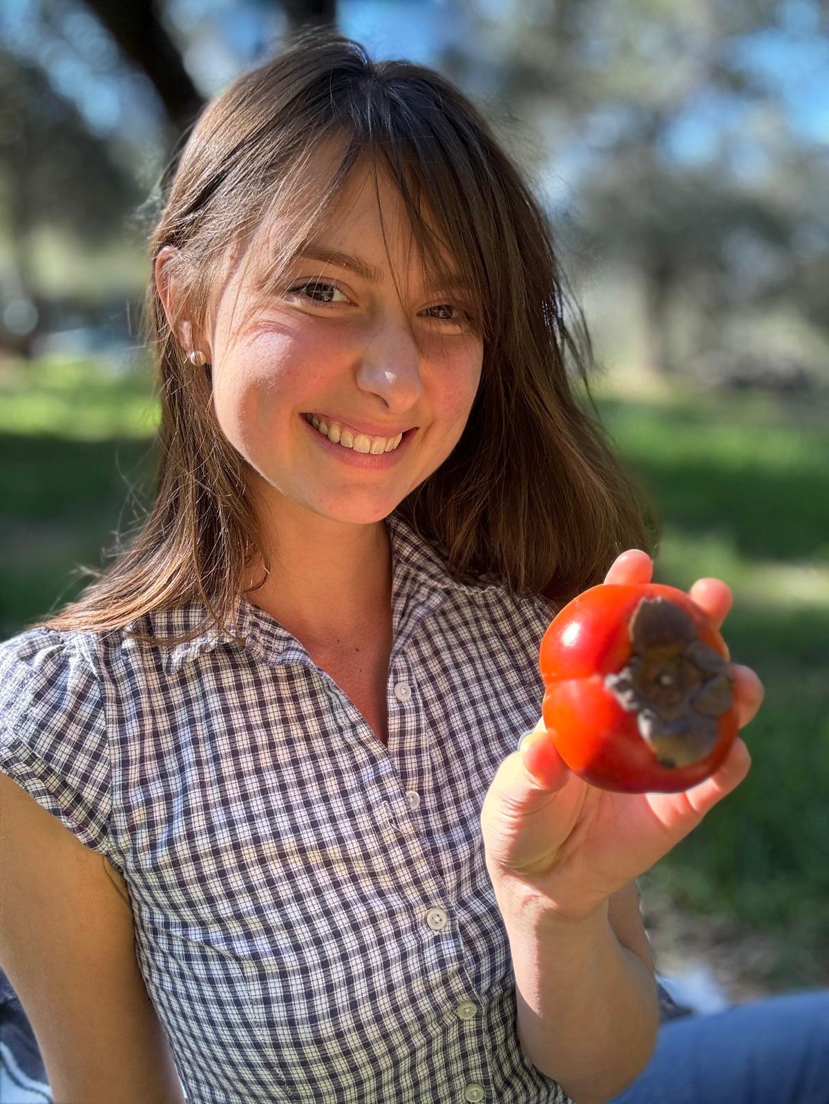 Gracie Lang holding a fresh tomato